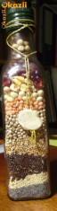 Sticla trasparenta, sectiune patrata, cu seminte naturale, divers colorate. foto