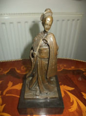 Statueta deosebita din bronz pe postam. din marmura neagra foto