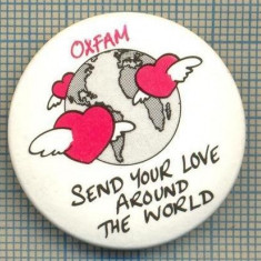 2028 INSIGNA - OXFAM-SEND YOUR LOVE AROUND THE WORLD(TRIMITE DRAGOSTEA TA IN JURUL LUMII)-SIMBOL-INIMI CU ARIPI IN JURUL GLOBULUI-starea care se vede