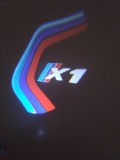 Set 2 Holograme LED Uși BMW X1 - Lumini Logo Proiector Auto