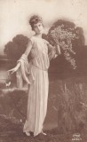 Femeie in rochie de inspiratie antica cu flori (scrisa 1928)