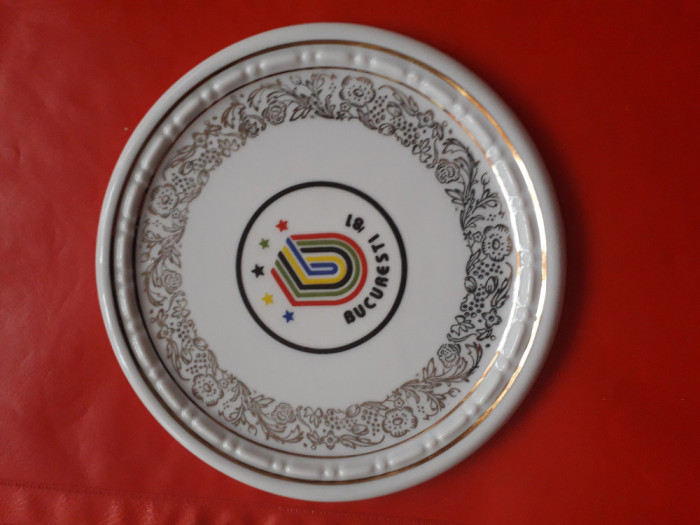 Aplică din porțelan reprezent&acirc;nd logoul Universiadei din București din 1981