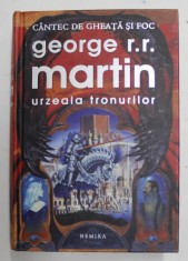 URZEALA TRONURILOR , SERIA CANTEC DE GHEATA SI FOC , EDITIA II - A de GEORGE R.R. MARTIN , 2011 *EDITIE DE LUX CARTONATA , PREZINTA URME DE UZURA foto