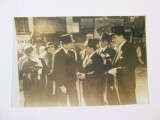 Copie foto 177x118 mm cu Titulescu și Savel Rădulescu la sosirea oficială &icirc;n Gara de Nord 1935,&icirc;n fundal se observă afișe:CFR-ONEF,Noul Hotel New York