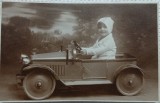 Fotografie tip Carte Postala, Baietel in masinuta, perioada interbelica