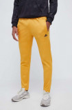 Cumpara ieftin Adidas pantaloni de trening culoarea galben, modelator