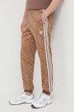 Cumpara ieftin Adidas Originals pantaloni de trening culoarea maro, cu imprimeu IS0257