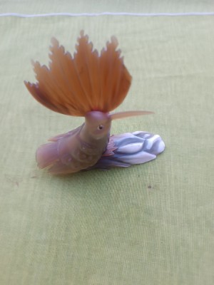 Pupaza, figurina sculptata in corn foto