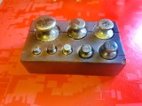 9263-Set 8 Greutati pentru cantar din metal vechi in cutie lemn stare mai uzate, curatite. Continand: 1X 200 grame,2X 100,1X 50, 1X 20, 2X 10 si 1X 5.