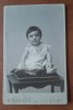 Fotografie tip CDV, copil mic pe bancheta, inceput de secol XX