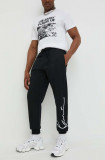 Cumpara ieftin Karl Kani pantaloni de trening culoarea negru, cu imprimeu 6004039-black