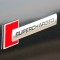 Emblema auto model &ldquo;SUPERCHARGED&rdquo;, reliefata 3D, dimensiune 10 x 1 cm