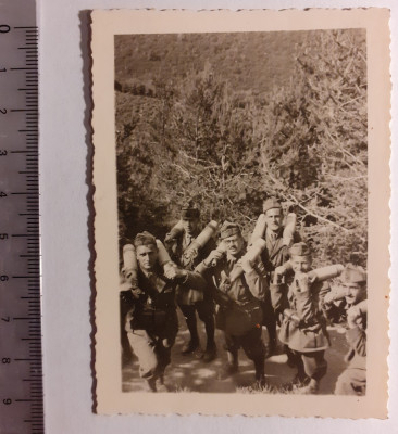 Fotografie cu militari căr&amp;acirc;nd niște obuze foto