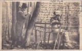 Cumpara ieftin Carte postala infatisand un tanar scriind rezemat de un copac langa o femeie pe