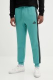 adidas pantaloni de trening Essentials culoarea turcoaz, cu imprimeu, JX0711