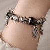 Bratara dama argintie Noirette cu pietre negre si albe, model cruciulita, lungime 19 cm, din metal