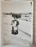 Fotografie cca 6/9 cm cu femeie cu c&acirc;ine &icirc;n brațe pe bloc &icirc;n 1936