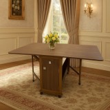 Masa plianta cu spatiu depozitare, usa si sertar, Pal Melaminat, structura lemn masiv, cu role, 8 persoane, 160x96x80 cm, nuc