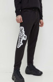 Cumpara ieftin Tommy Jeans pantaloni de trening culoarea negru, cu imprimeu DM0DM18376