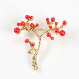 Brosa martisor ramura aurie cu pietre rosii