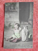 Fotografie tip carte postala, fetita langa un recipient cu apa, inceput de secol XX