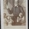 Fotografie tip CDV, preot catolic Filip Neri cu cativa copii, inceput de secol XX