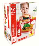 Set fast-food din lemn Hape cu burger, hot dog si accesorii, 3 ani+