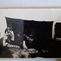 Fotografie tip CP cu femeie cu pipă pe pat