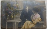 Fotografie tip Carte postala, Barbat si femeie langa bradul de Craciun, perioada interbelica