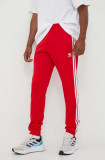 Cumpara ieftin Adidas Originals pantaloni de trening culoarea roșu, cu imprimeu IM4543