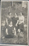 Fotografie tip Carte Postala, Patru femei si un caine, in curtea casei, perioada interbelica